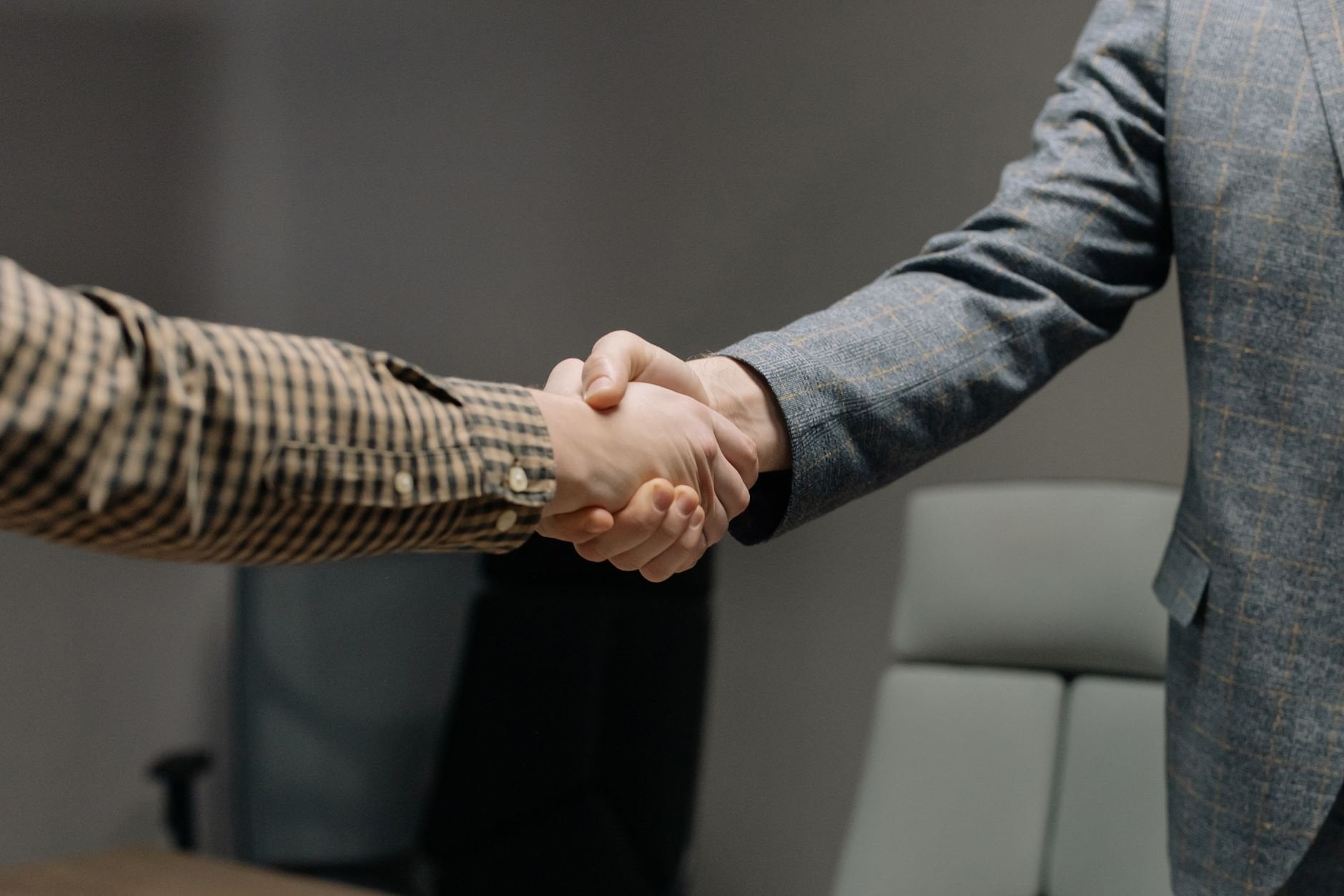 Two professionals shaking hands, symbolising verified business partnerships